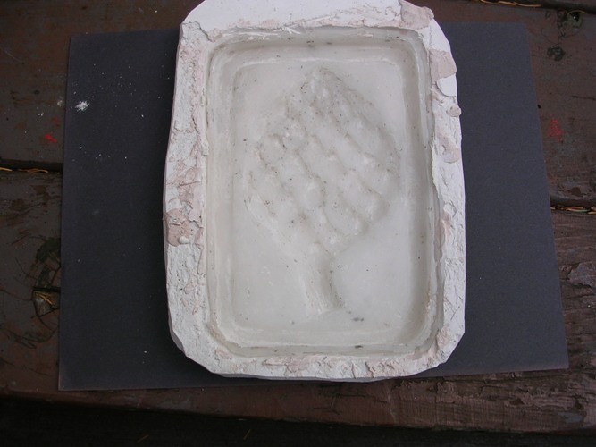 A silicone mold in its plaster casing.